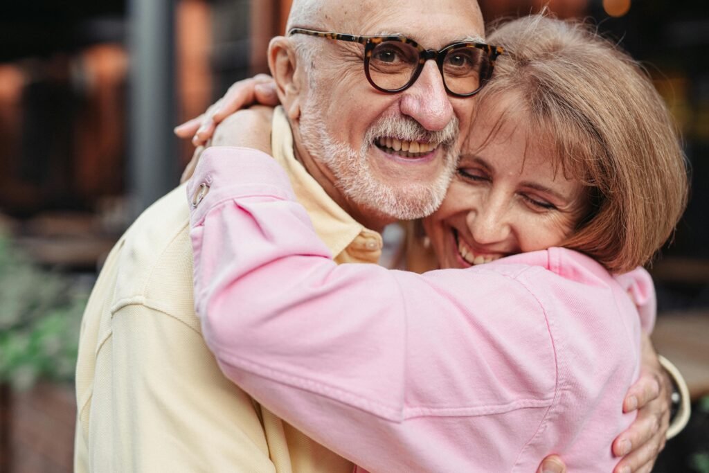 Man in Yellow Shirt and Eyeglasses Hugging Woman in Pink Shirt